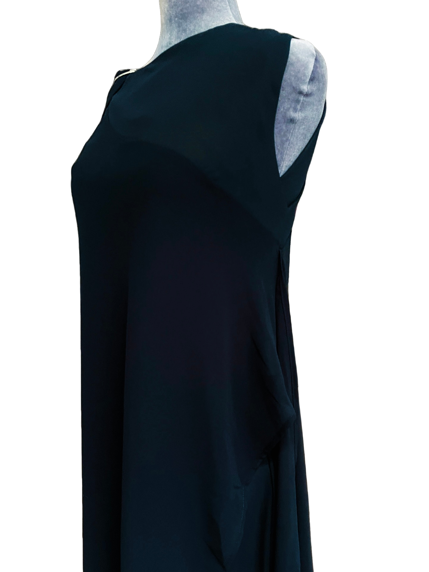 Close-up of MØRKE Solveig upper dress — black one-shoulder overlay with fluid drape and soft translucent layer, shown on a mannequin. Versatile piece designed to be worn alone over jeans or trousers, under a blazer, or styled as a cape